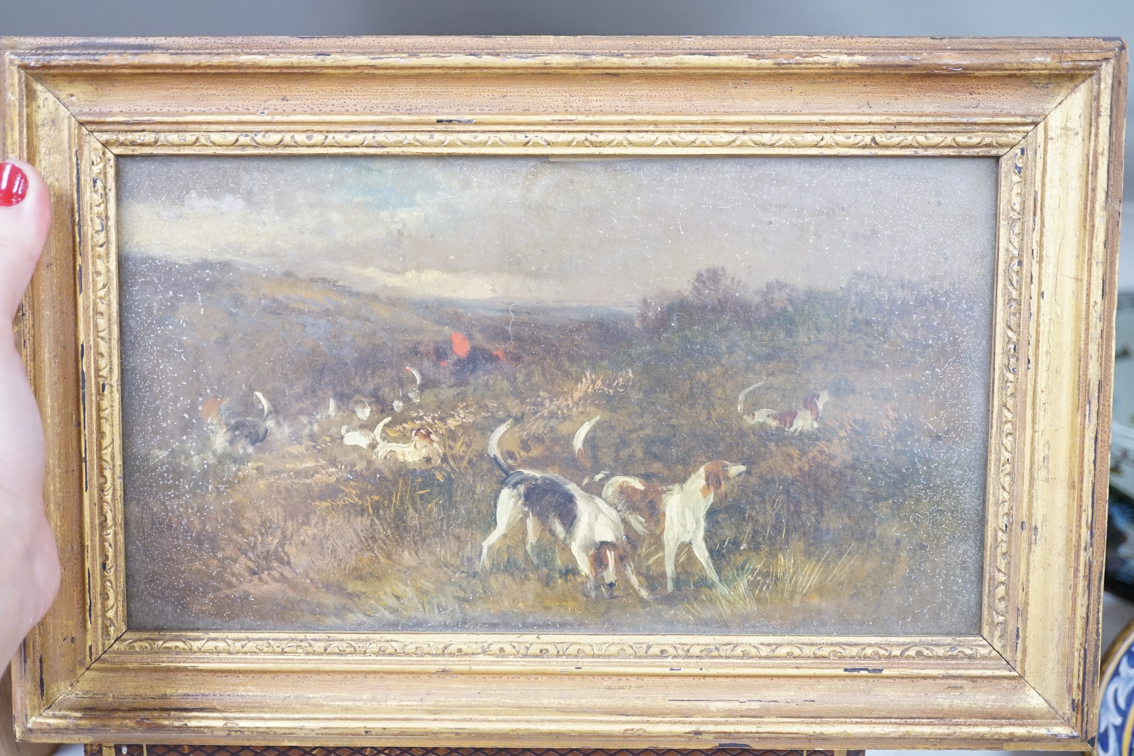 19th century, two oils on board, Hunting hounds in a landscape and Rocky landscape, largest 14.5 x 26cm, each gilt framed. Condition - fair